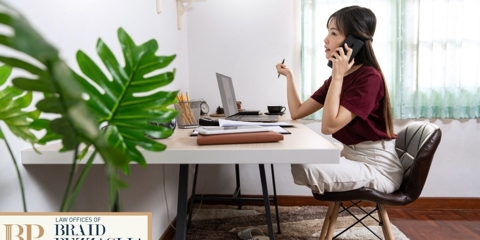 Woman sitting at desk on the phone