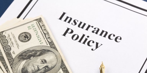 Insurance policy and hundred dollar bills