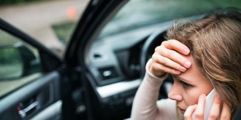 woman on the phone after a car accident
