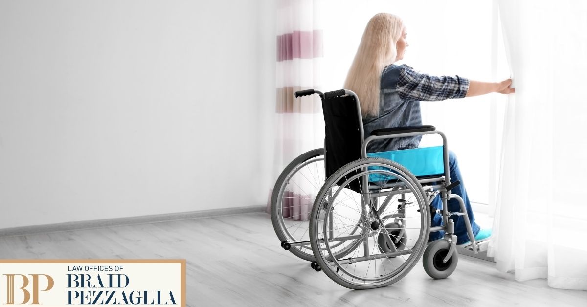 Woman in wheelchair looking out of window