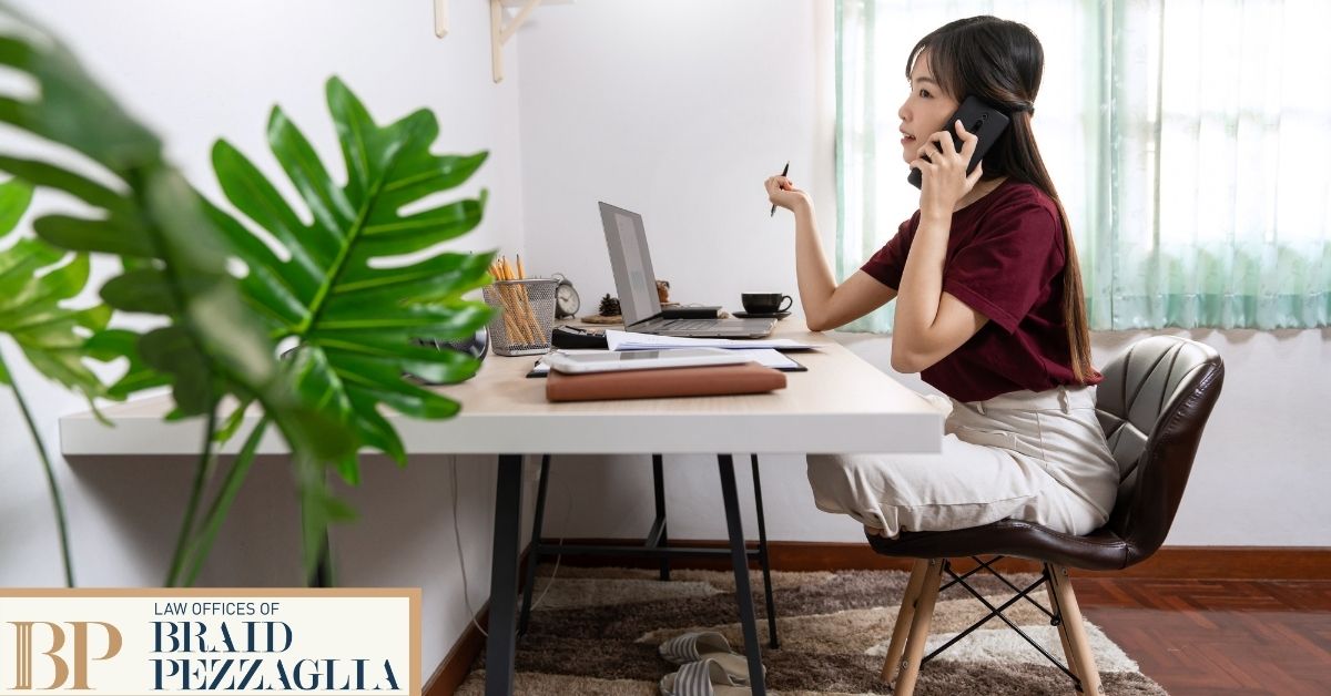 Woman sitting at desk on the phone