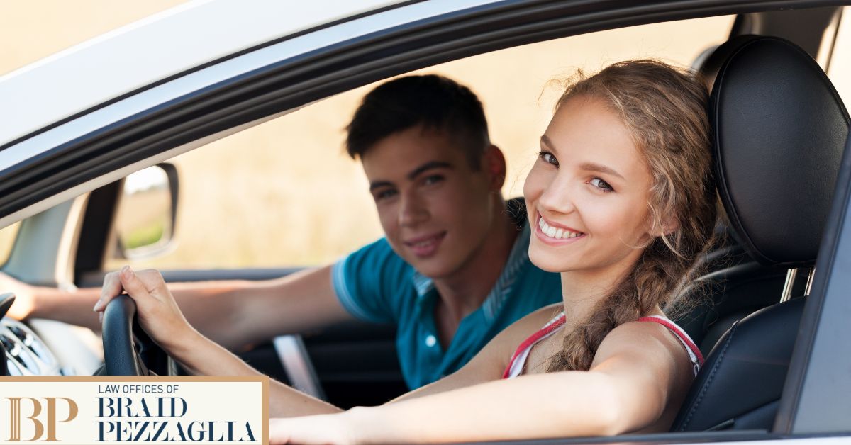 Woman and man sitting in the driver and passenger seat.