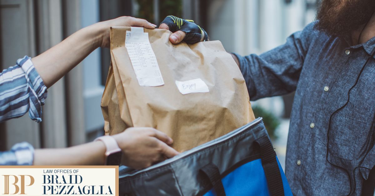Delivery driver handing customer food