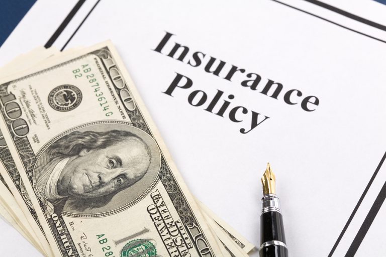 Insurance policy and hundred dollar bills