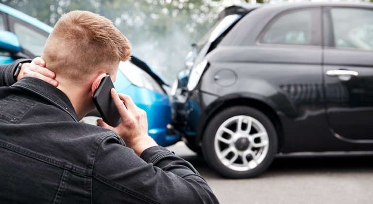 Man on the phone after a car accident