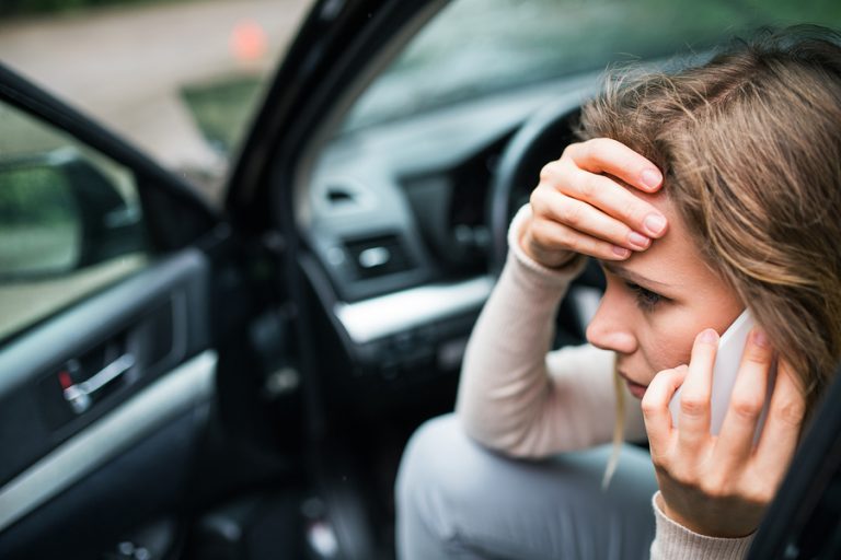 woman on the phone after a car accident